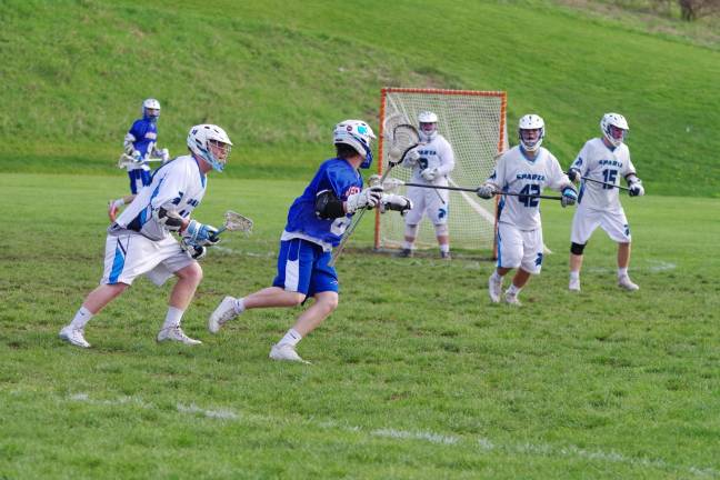 Spartans top Blue devils in boys lacrosse Westfield's Nick Nolan looks towards the goal post as he carries the ball.