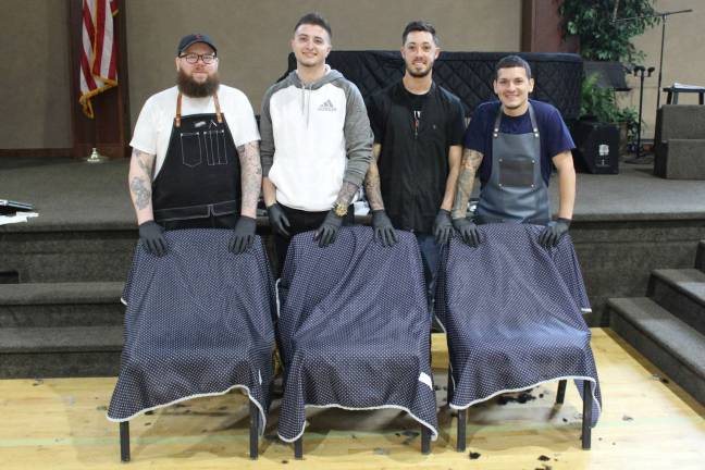 Volunteers step up for homeless vets at Stand Down From left, Chris Bassani, Zack Kroenfeld, Tony DiBernard and Manny Galicia, of A Cut Above in Sparta. They provided vets with haircuts.