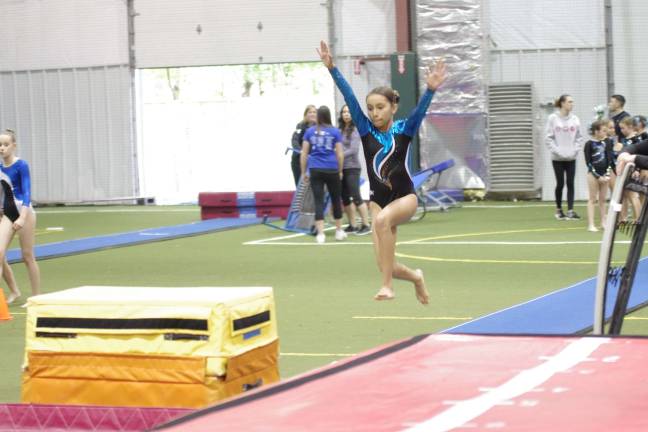 'Wild About Power' meet A Gymnastics Inc. gymnast glides through the air. Gymnastics Inc is located in Kenvil.