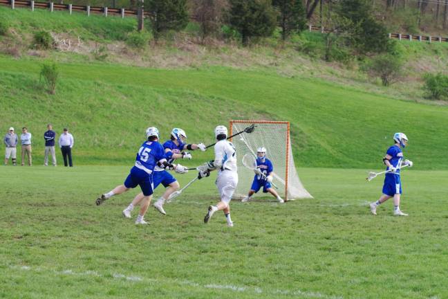 Spartans top Blue devils in boys lacrosse Sparta's Jack Valentine launches the ball towards the goal post as Westfield goal keeper Theo Dardia stands guard. Valentine scored one goal.