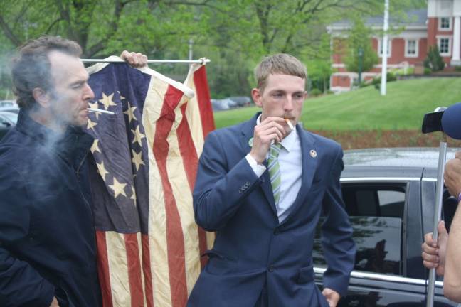 Scott Waselik, right, and a supporter smoke marijuana outside the courthouse in Sparta in a 2014 protest against Waselik's arrest.