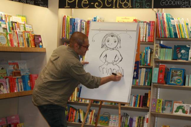 Ladybug Girl creators come to Sparta Books Illustrator David Soman puts the finishing touches of a tutu on the Ladybug character.
