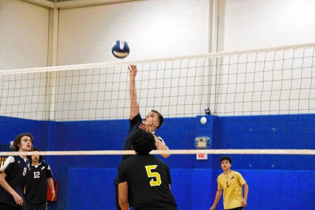 Pope John's Ben Giralt reaches for the ball.