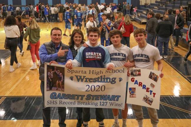 Senior Garrett Stewart is surrounded by his team after he completed his record making match.