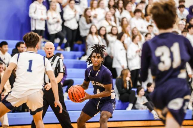 Pope John’s Prince Joshua looks for a place to pass the ball.