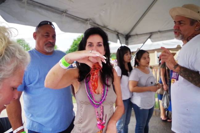 Crawfish fest goes 'down home' PHOTOS by GEORGE Leroy Hunter Carolyn Kostialik tastes her first crawfish.