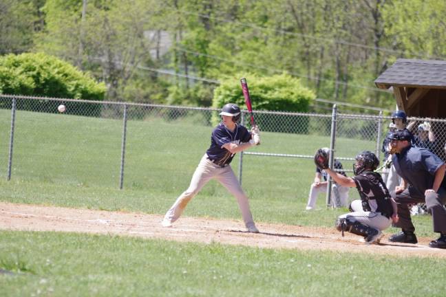 A pitched ball moves towards Sparta batter Mike Nauta in the second inning. Nauta scored three runs.