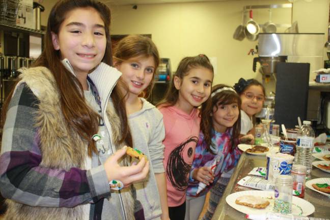 Pass it along holds Family Volunteer Day Cookie makers hard at work. From left, Sarah Steele, Ava Castellana, Aaliyah Giuffrita, Natalie Torres and Amanda Torres.