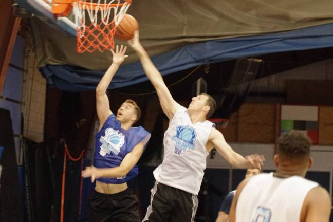 Summer Basketball League The ball is batted away by Team Tobin's Almin Hodzic (white) after a shot attempt by Team Melville's Jason Heter in the second half.