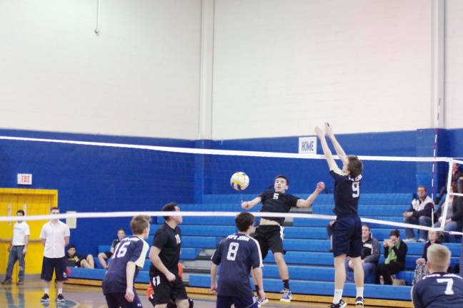 Pope John's strikes down Dover in volleyball The ball gets caught in the net after being struck by Dover's Samuel Alexander