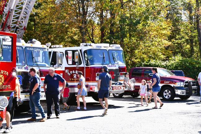 Sparta Township observes Fire Prevention Week Visitors look at the fire trucks.