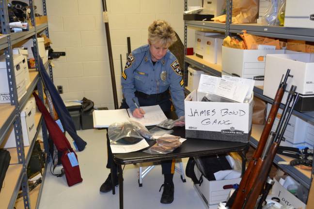 Busted! Photo courtesy of Sparta Police Department Cpl. Susan Parkes Sparta P.D.þÄôs evidence custodian, inventories and logs in the proceeds and evidence from Sparta PoliceþÄôs latest arrest of the burglary ring from Bergen County known as the James Bond Gang.