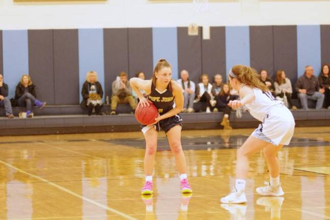 Pope John's Carly Fitzmorris holds the ball while facing Sparta's Ally Sweeney in the third quarter. Fitzmorris scored 12 points.