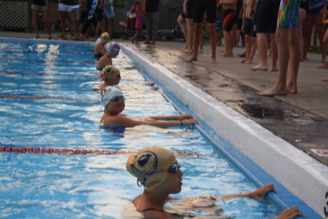 Swim team falls in home meet Girls ages 11-12 get ready for backstroke race.