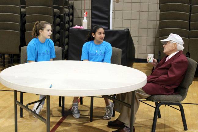 Volunteers step up for homeless vets at Stand Down From left, Maddie Accurri and Raina Dhand of Sparta, with a Korean & Vietnam War veteran who serves as chaplain for the National Guard. Photos provided by PIA