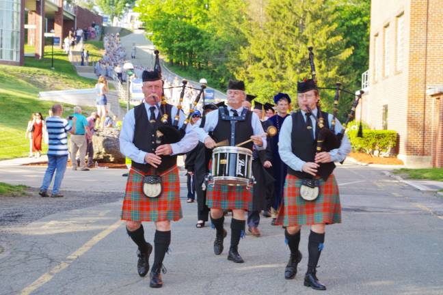 Gaelic Pipe Band of Kearny members Michael McGonigal, Joe McGonigal and Sean McGonigal lead the procession of faculty and soon-to-be-graduates.