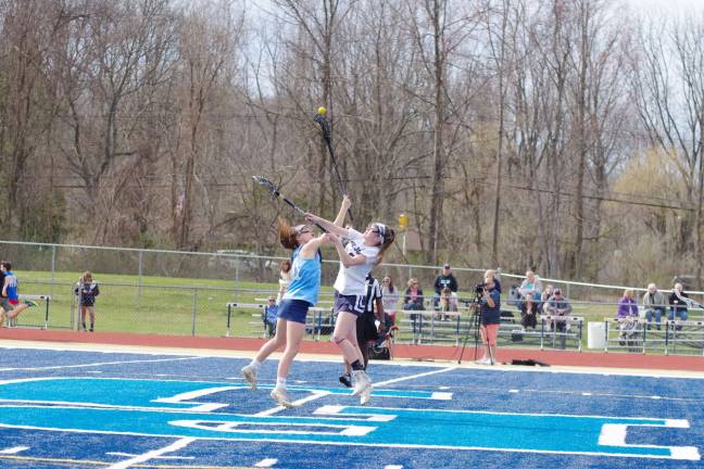 Mead leads Sparta girls to lacrosse victory over Pope John Sparta's Mead and Pope John's Emma Valiante leap for the ball.