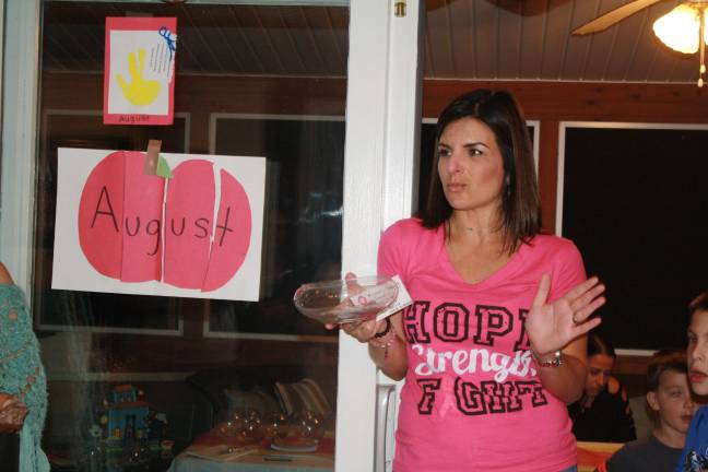 Raising funds to combat breast cancer The hostess with the mostest; Nicole Chiong calls the raffle winners at her breast cancer fundraiser PHOTOS BY ROSE SGARLATO