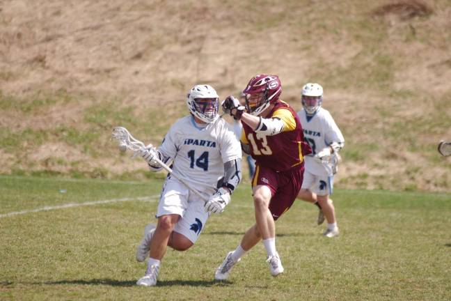 Summit tops Sparta in boys lacrosse While advancing the ball Sparta's Stelios Kroudis gets resistance from Summit's Jackson Tyler.