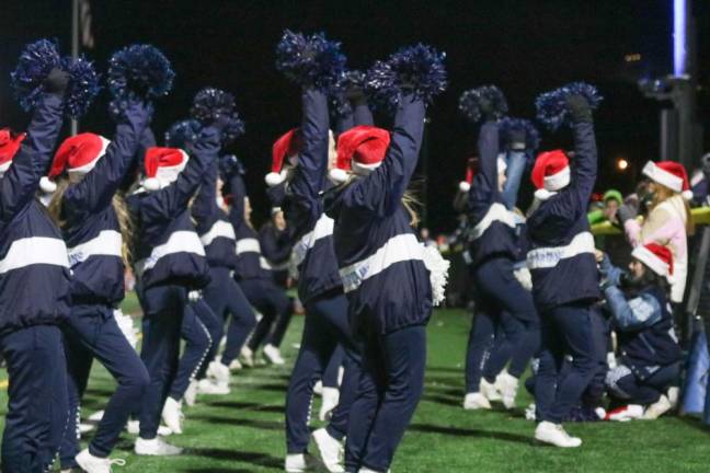 Santa hats were perfect for a bitter cold night as the Sparta Cheer team performs.