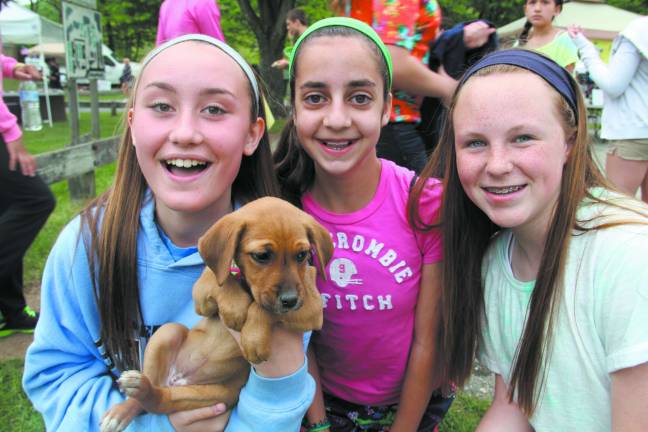 Bounce houses, face painting and more at Sparta Day Blake Aschenbach, Marirose Fischer and Amanda Sandow of Sparta with an OSCAR rescue puppy.