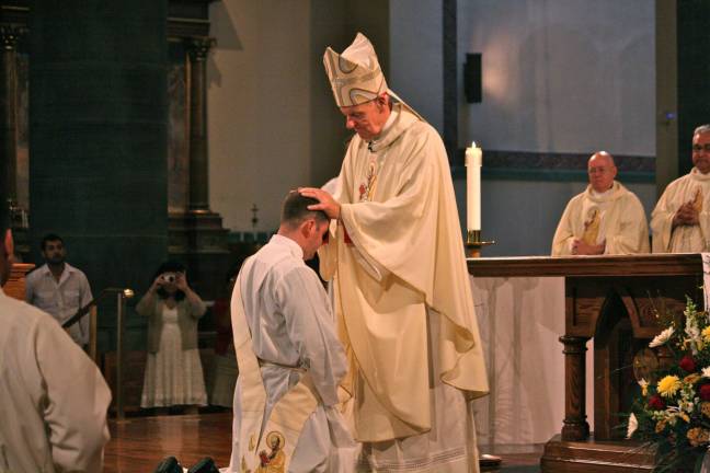 Knights-sponsored seminarian is ordained Father Tom Gibbons receives a blessing from Bishop Walter Hurley during his ordination at St. Paul the Apostle
