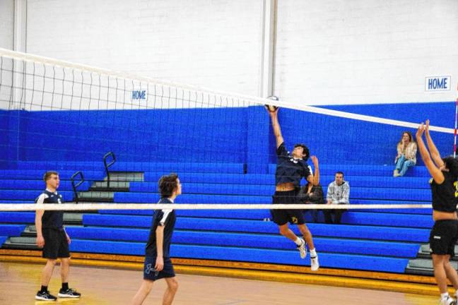 Pope John's Roman Concha gets a hand on the ball above the net during the game Friday, April 5 against Bergen Charter. The Lions lost, 2-0. (Photos by George Leroy Hunter)