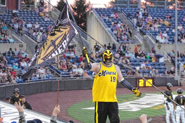 Miners lead division <b>Miner Man carries the team flag.</b>