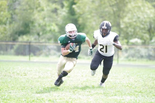 Sussex Tech ball carrier Brendan Hall is pursued by Hudson Catholic defender Jalen Best in the second half.