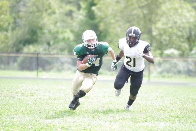 Sussex Tech ball carrier Brendan Hall is pursued by Hudson Catholic defender Jalen Best in the second half.