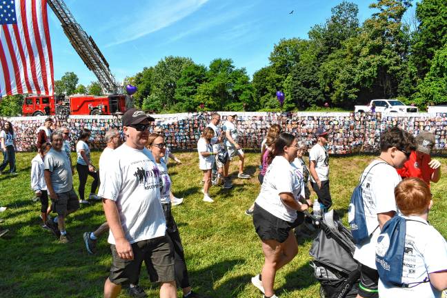 700 walk to change face of addiction Participants walk past photos of those who died from addiction.