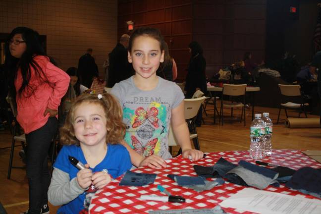 Pass it along holds Family Volunteer Day Sisters Gwen and Kristen Silipena of Hardyston Township decorate denim pieces for Freedom Gratitude Quilt.