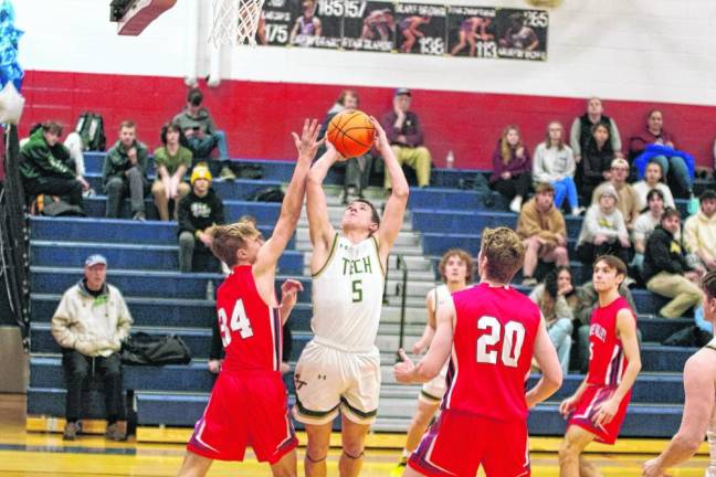 Sussex Tech's Will White handles the ball during a shot. He scored 20 points.