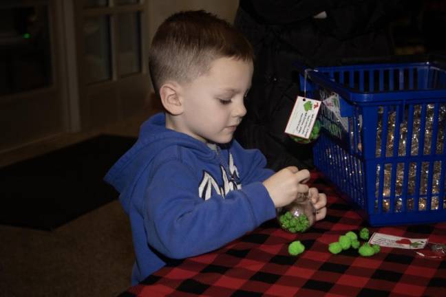 Foster Pierson, 4, makes an ornament.