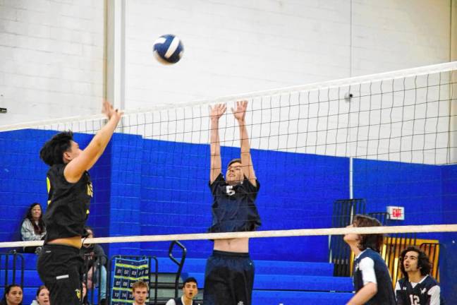 Pope John's Zachary Nowel (5) reaches for the ball.