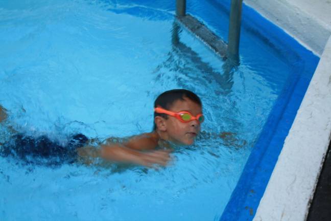 Swim team falls in home meet Danny Westervelt, 7, completes his race.