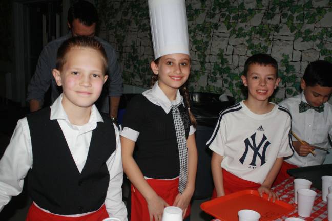 Kids serve parents at Annual Spaghetti Dinner Patrick Fitzsimmons, Ava Sahring and Kayden Daly filling up at the beverage station. Photos by Rose Sgarlato