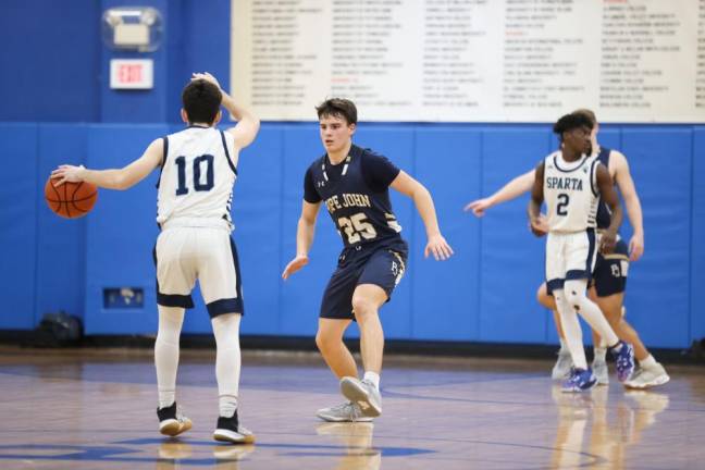 Pope John’s Anthony Schnabel defends against Sparta’s Pat Connors.