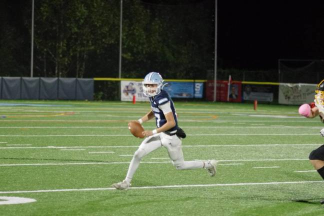 Sparta quarterback Shane Hoover on the run.