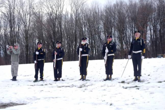 A member of the honor guard plays taps at the ceremony.