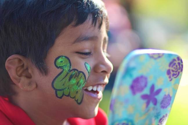 Priyanka, age 4, is thrilled with his freshly painted Dinosaur.