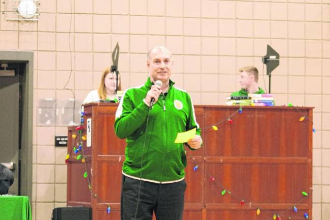 Veritas Christian Academy head basketball coach Armand Milanesi speaks during a halftime ceremony Dec. 21. (Photo by George Leroy Hunter)