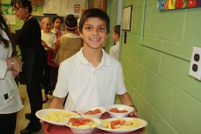 Kids serve parents at Annual Spaghetti Dinner Waiter Jaisen Caswell has no problem balancing his tray at Helen Morgan's Spaghetti Night.