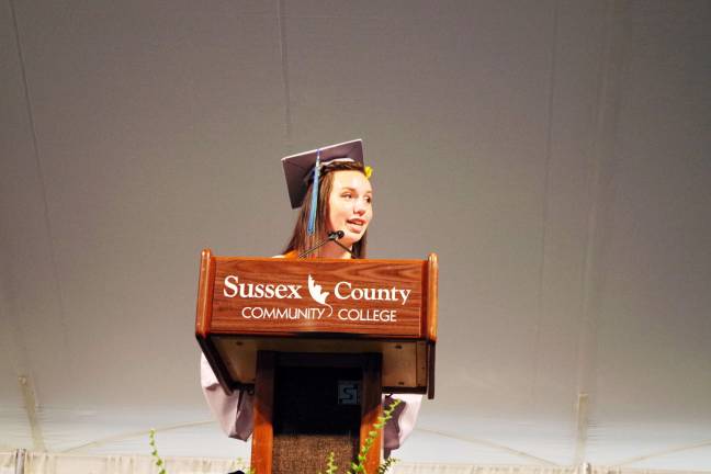 Graduate and student spokesperson Amelia Macchietto (A.A. Liberal Arts) of Newton speaks at the commencement. Macchietto is the organizer of the school's newly opened Horton Food Pantry.
