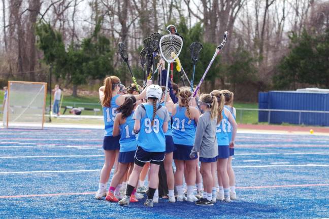 Mead leads Sparta girls to lacrosse victory over Pope John The Lady Spartans raise their crosses just before the start of the lacrosse game.