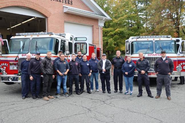 SF4 Members of the department with the firetrucks.