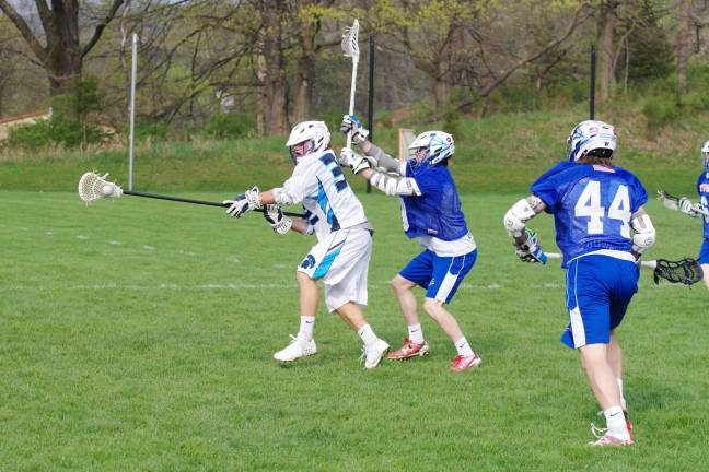 Spartans top Blue devils in boys lacrosse Sparta's Austin Castorina carries the ball as Westfield defenders close in.