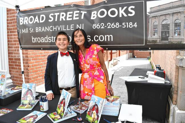 Young author’s book deals with big themes Sue-Ni DiStefano, co-owner of Broad Street Books, poses with young author Zy Saturnees.