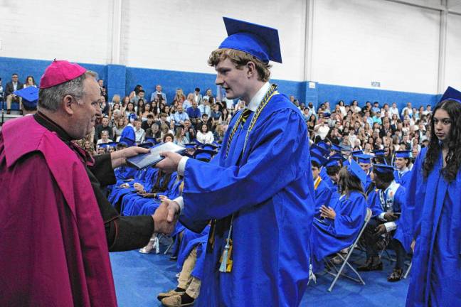 Photos: Pope John XXIII Regional High School graduation Bishop Kevin Sweeney of the Diocese of Paterson hands out diplomas.