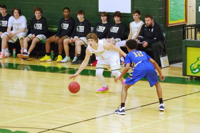 Sussex Tech's Frank Cunha dribbles the ball while covered by Manville's Steve Purcell. Cunha did not score any points but managed to grab 4 rebounds, made 3 assists and is credited with 1 steal.